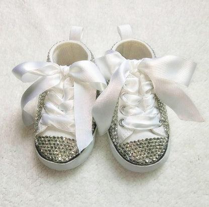 Pair of handmade glitter Mary Jane infant shoes in a vibrant pink, embellished with a sweet decorative bow.