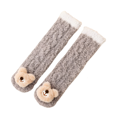 Collection of various colored lamb's wool baby winter socks, extra plush for infant comfort.