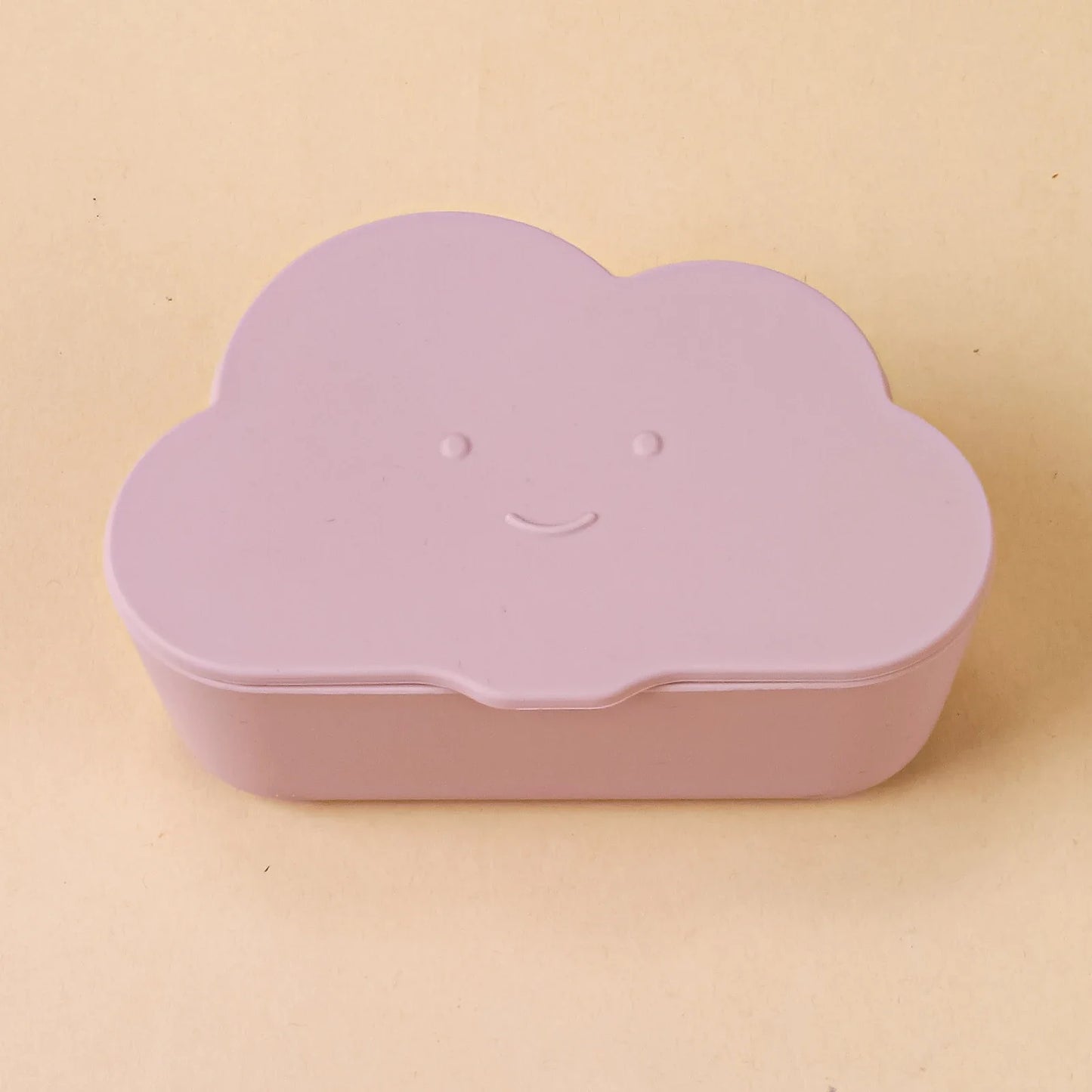 Toddler holding a white cloud snack container, demonstrating its ease of use for little hands.