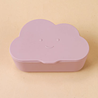 Toddler holding a white cloud snack container, demonstrating its ease of use for little hands.