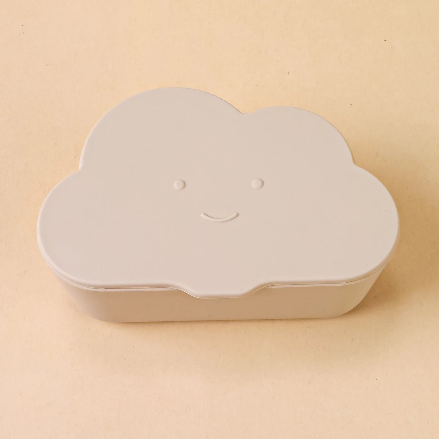 Overhead shot of a cloud snack container, lid detached, with small snacks inside for children.