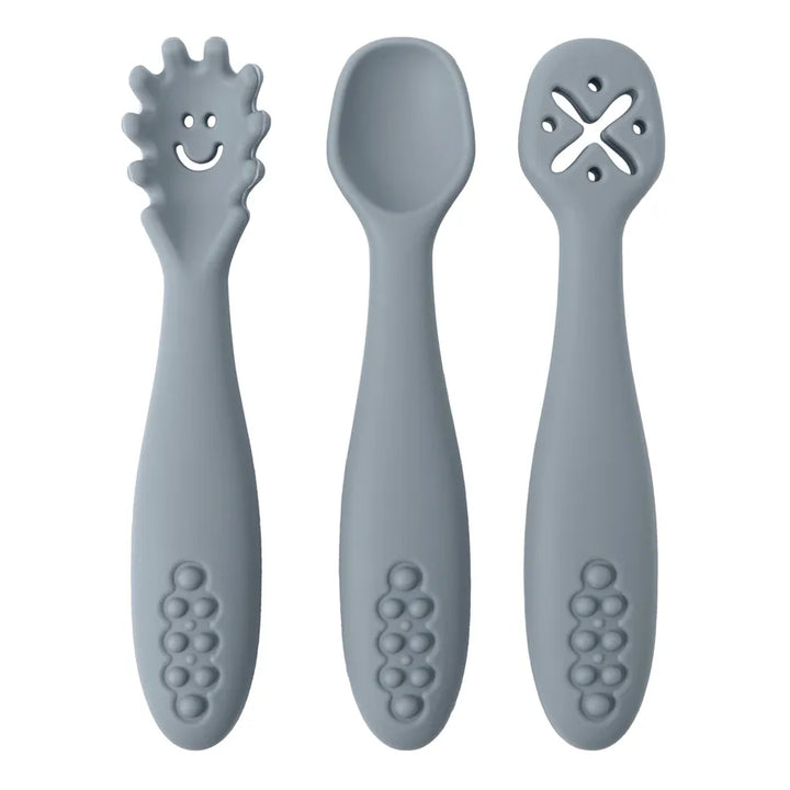 Full view of 3-piece silicone baby utensil set. Includes soft spoon, learning fork & another utensil.