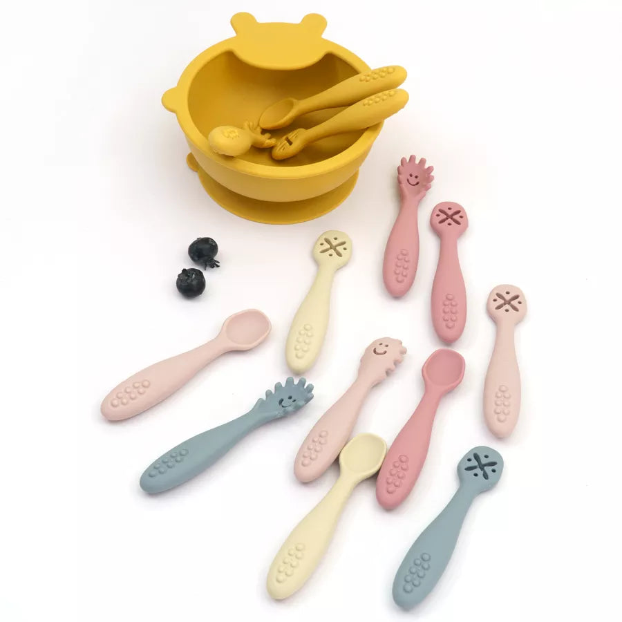 Brightly colored silicone baby utensils promoting independence at mealtime. 3-piece spoon & fork set.
