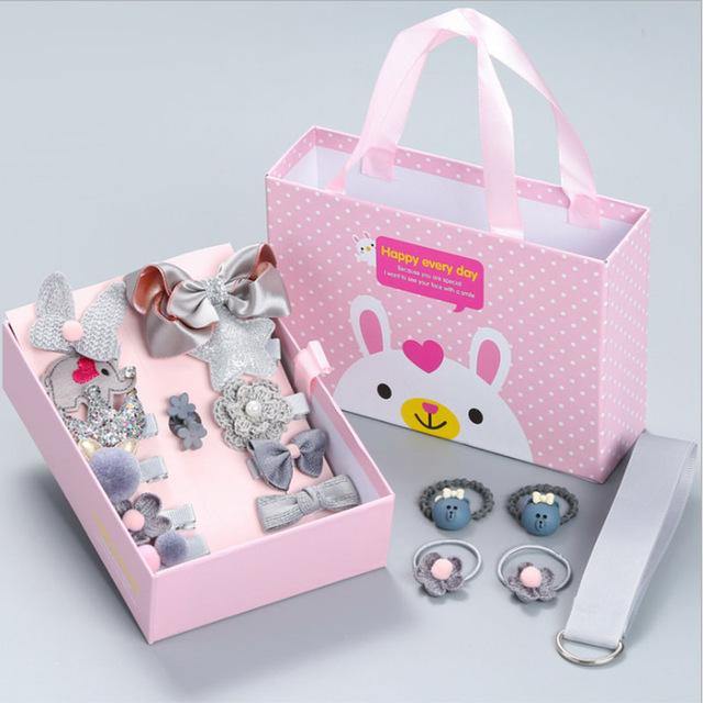 Open gift box revealing a selection of microfiber hair clips & colorful hair bands for girls.