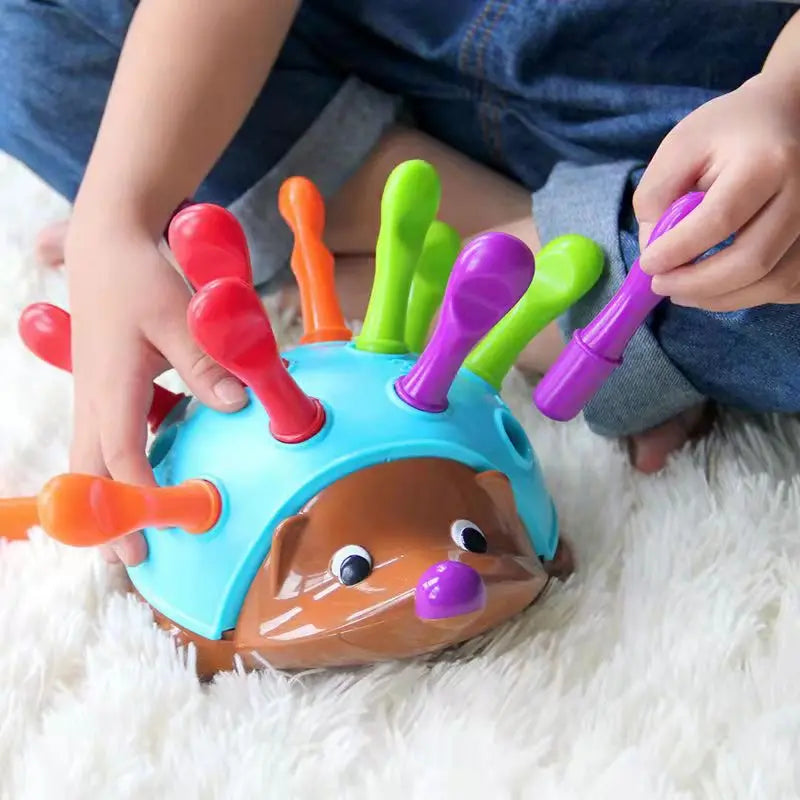 Toddler playing with an educational montessori hedgehog toy, developing fine motor skills