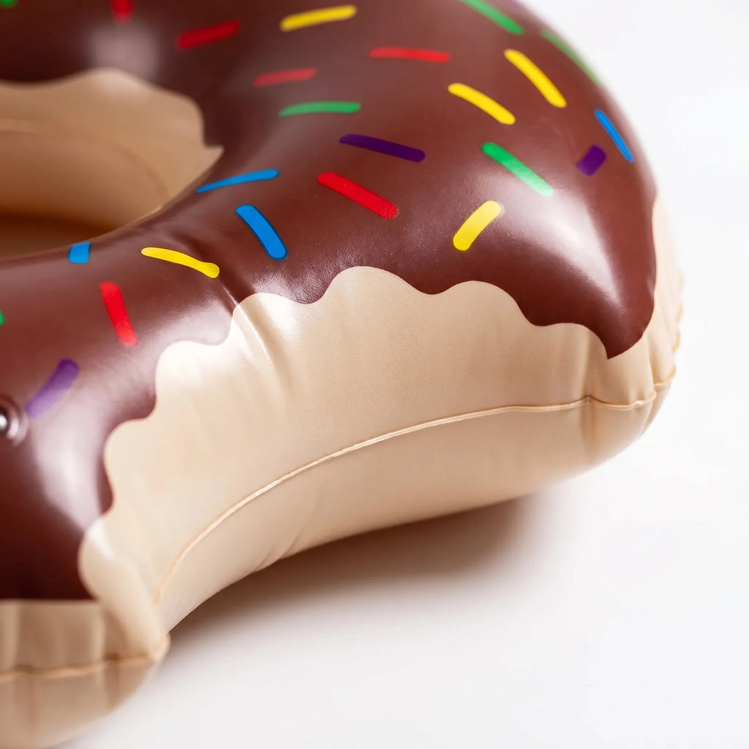 Giant inflatable donut pool ring. Colorful water toy for summer fun, relaxation, & outdoor pool adventures.