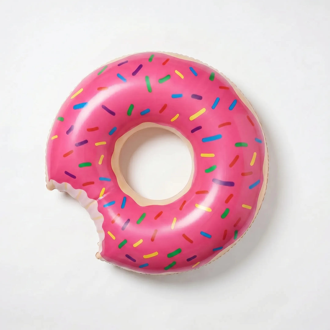 Whimsical donut-shaped inflatable ring for pools. A colorful summer essential for lounging, swimming & outdoor fun.