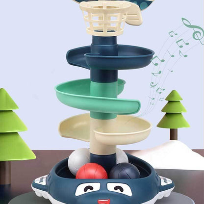 Child delightedly playing with an interactive stacking ball drop toy, learning cause and effect
