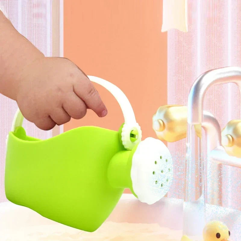 Toddler reaching for a bright yellow sand bucket and red shovel from a multi-piece beach toy set