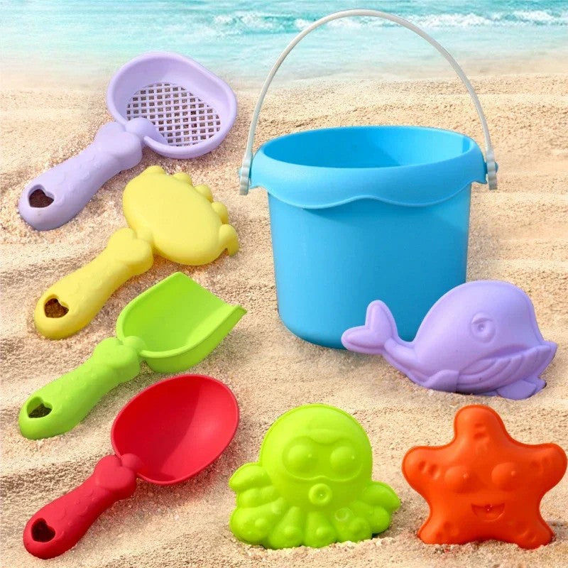 Close-up of vibrant plastic sandcastle molds and tools from a kids' summer outdoor activity set