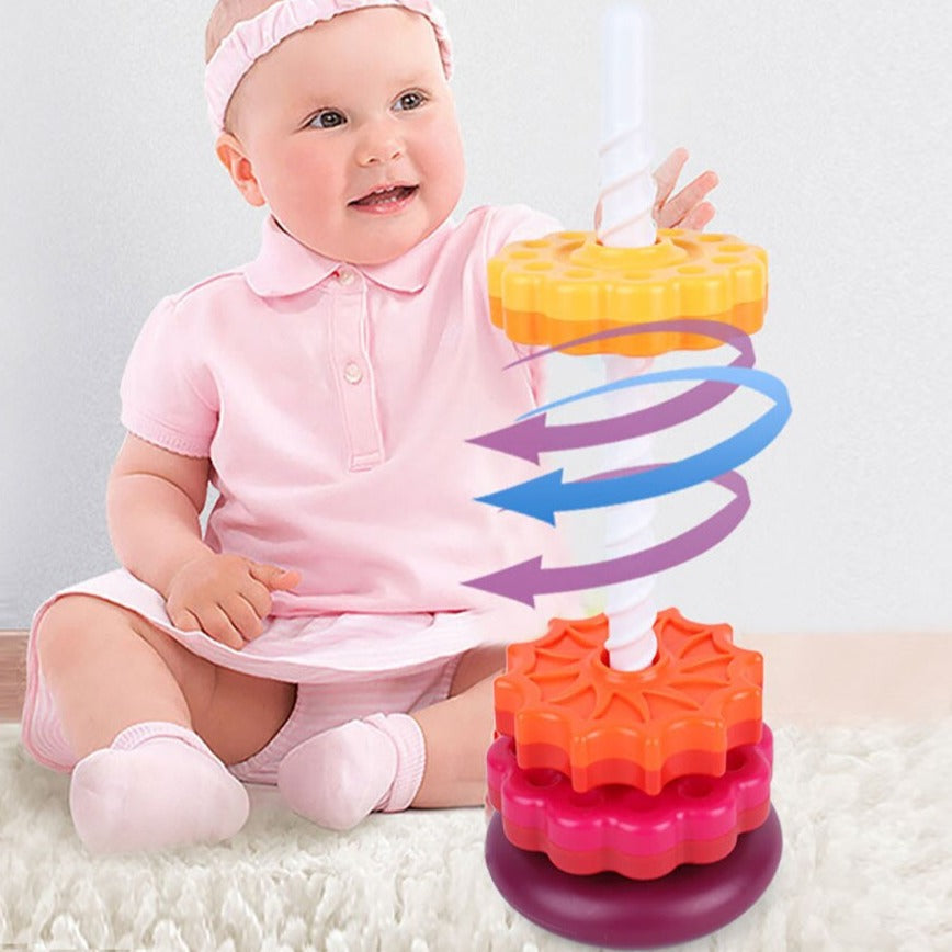 Children's stacking toy with rainbow rings and rotating base, ideal for developing motor skills.