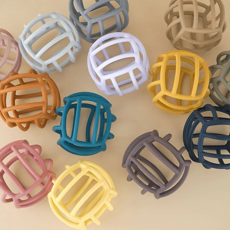 Playful design silicone teether ball, stimulates senses while providing teething comfort for infants.
