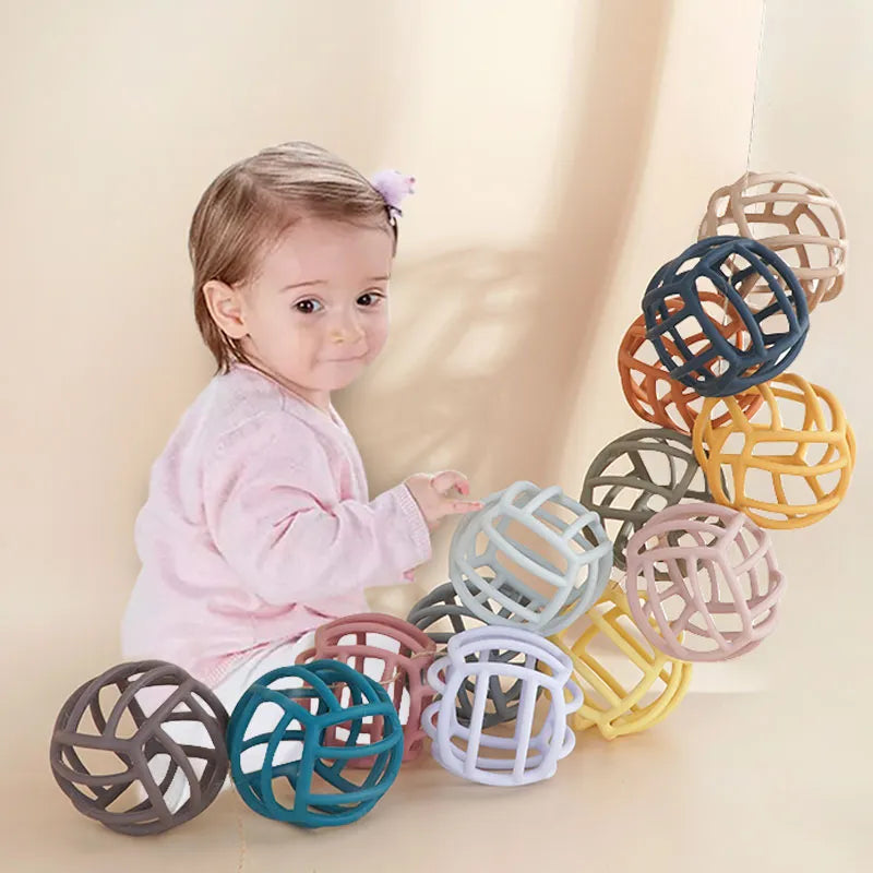 Compact silicone teether ball, perfect baby toy for on-the-go teething relief and sensory engagement.