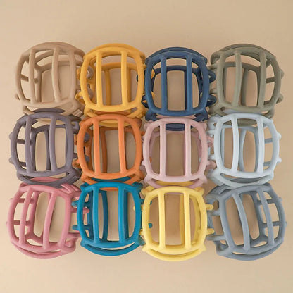 Baby silicone teether ball in vibrant colors, a safe chew toy for teething relief and sensory play.