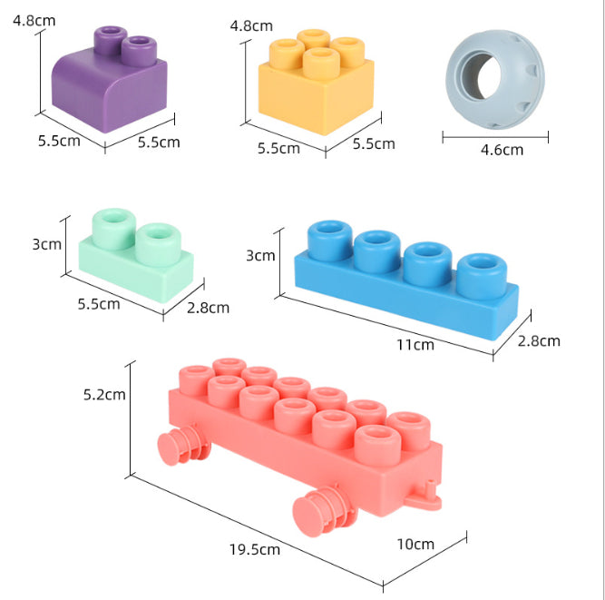 Baby playing with colorful soft silicone building blocks, engaged in educational construction activities