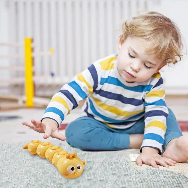 Close-up of a bright wind-up crawling caterpillar toy, designed for baby activity and toddler play.