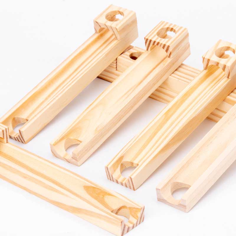 Kids building intricate designs with a wooden ball track stacking blocks construction set, imaginative play