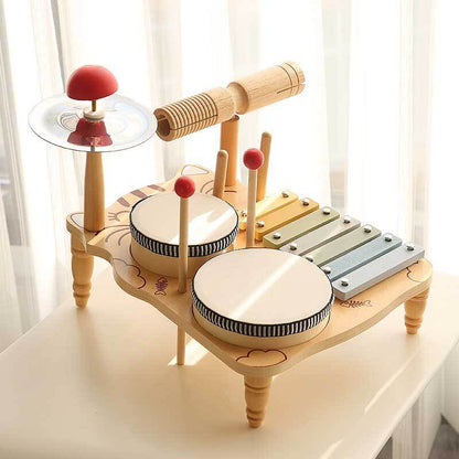 Close-up of a sturdy wooden drum set for children, featuring drums, cymbal, and mallets.