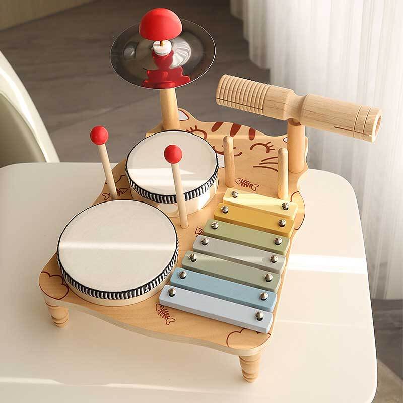 Preschooler happily engaging with a multi-piece wooden kids' drum set, perfect for learning.