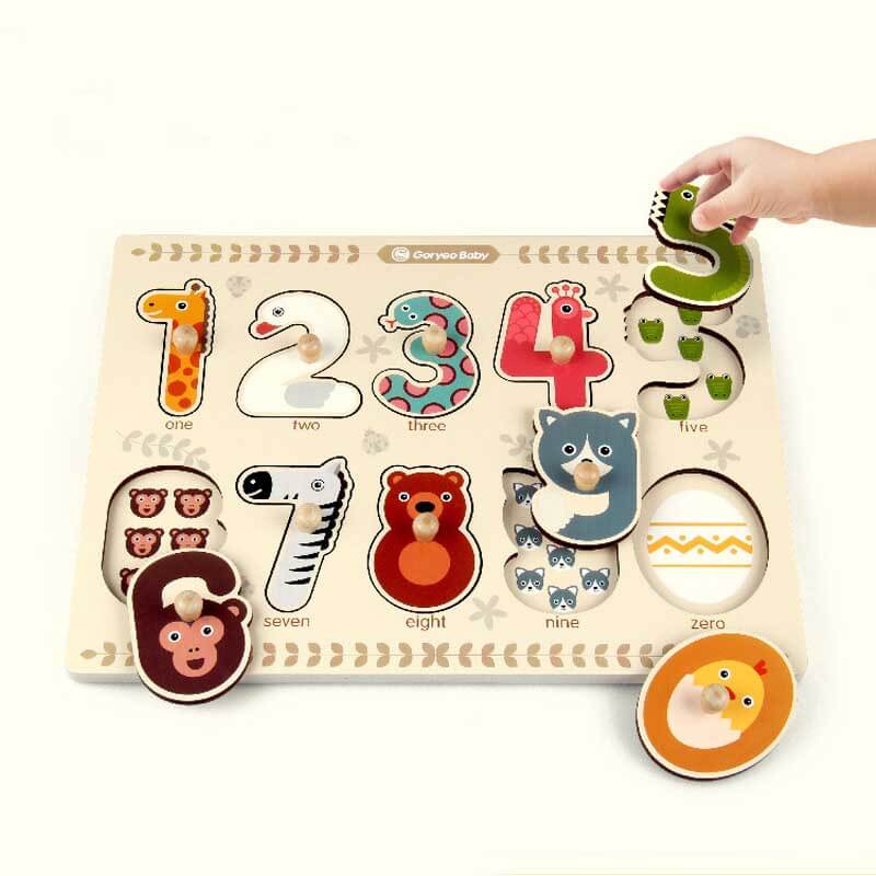 Toddler playing with a wooden animal number puzzle, learning counting and shapes