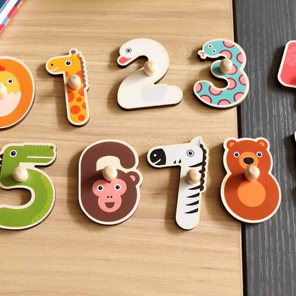 Preschool learning activity: a child matching wooden numbers to animal slots in a puzzle