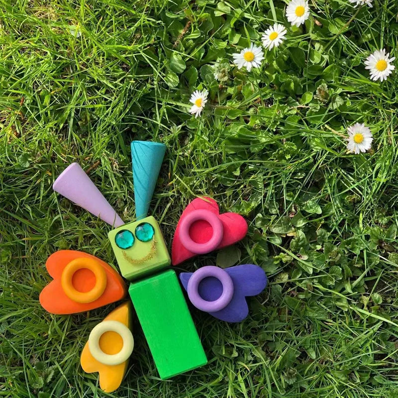 Montessori-inspired wooden rainbow stacker toy, showing individual arch pieces for early learning.