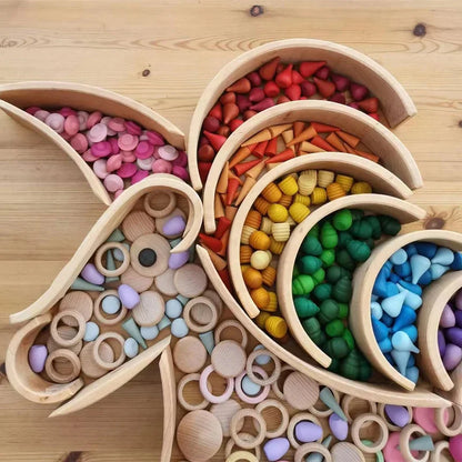 Educational wooden rainbow stacker blocks arranged creatively, demonstrating open-ended play possibilities.