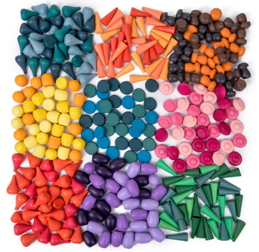 A deconstructed wooden rainbow stacker, showing each colorful arch block ready for stacking games.