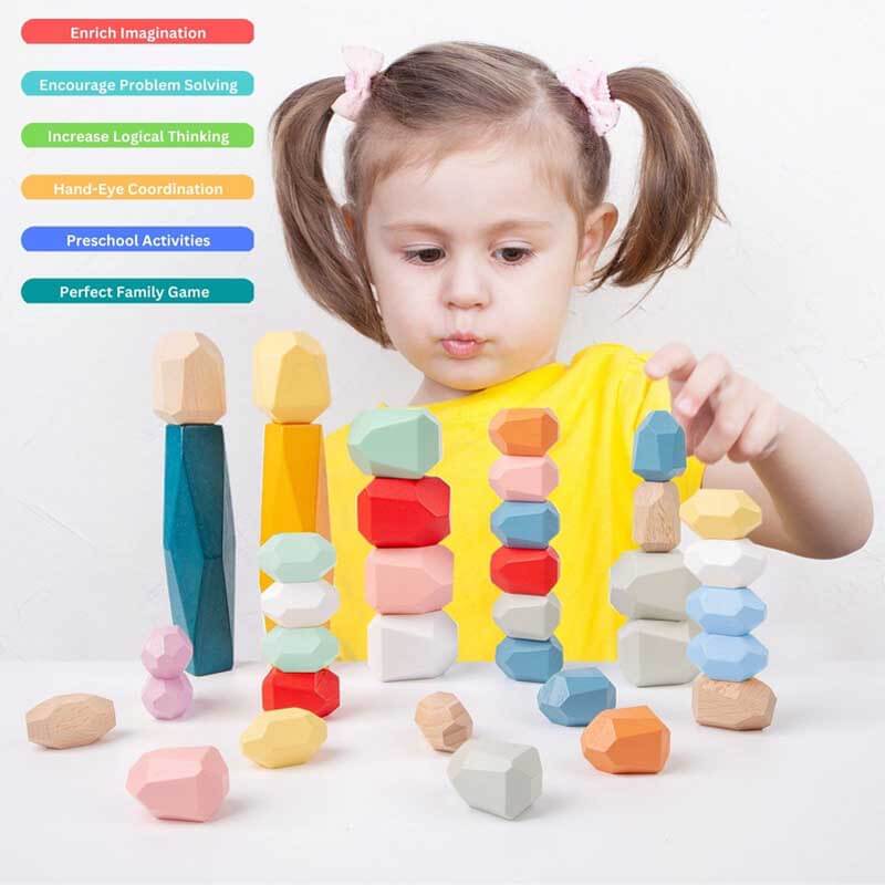 Toddler arranging wood rock blocks, developing hand-eye coordination with this Montessori toy.