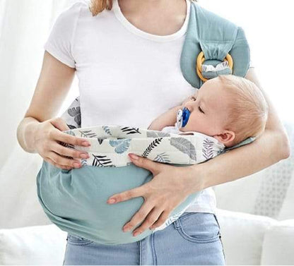 Toddler comfortably snuggled in a beige organic cotton Comfort 3-in-1 baby sling wrap carrier