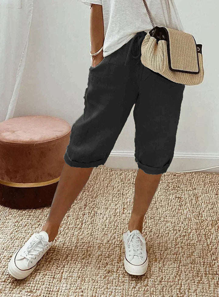Soft polyester capri pants for women, offering lightweight comfort & chic style. Elastic waist, perfect summer bottoms.
