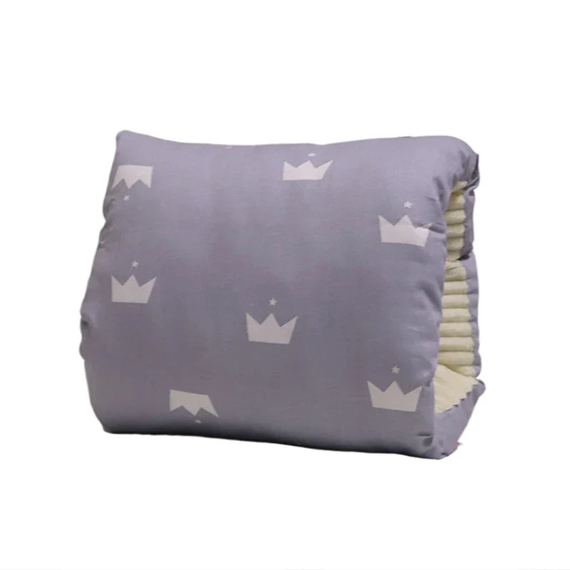 New mom smiles while breastfeeding with the supportive Comfy Cradle Nursing Arm Pillow.