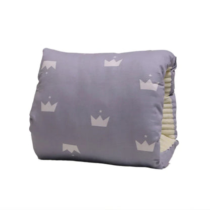 New mom smiles while breastfeeding with the supportive Comfy Cradle Nursing Arm Pillow.