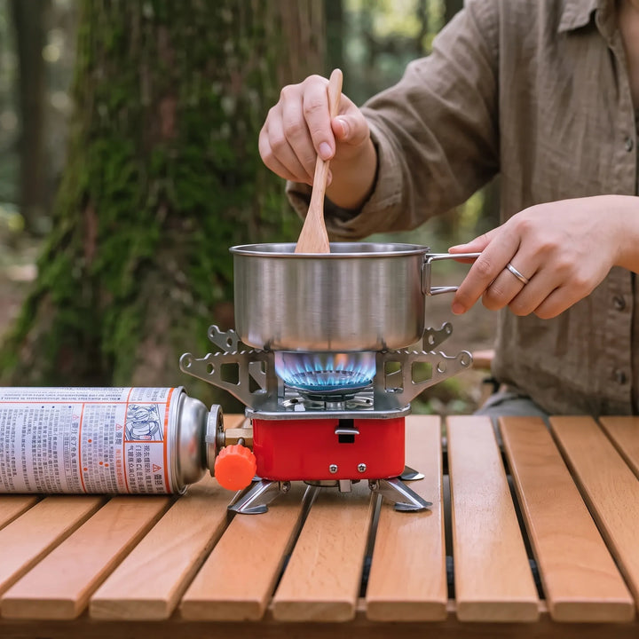 Lightweight portable folding camping stove, perfect for backpacking and hiking. Essential outdoor cooking gear.