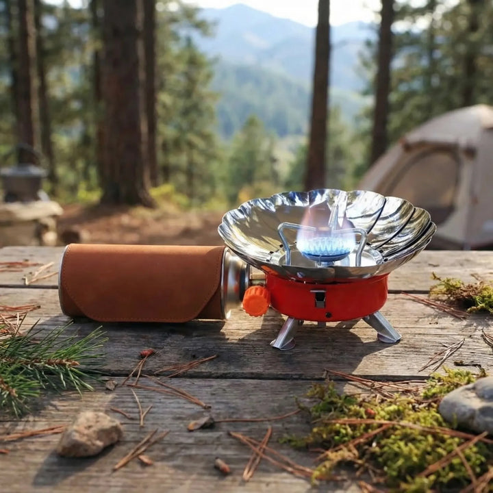 Compact folding camping stove for outdoor cooking, windproof portable burner, ideal for hiking and backpacking.