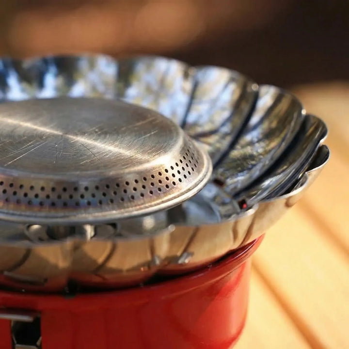 Folding outdoor camping stove with windproof design, portable burner for efficient cooking on hiking trips.
