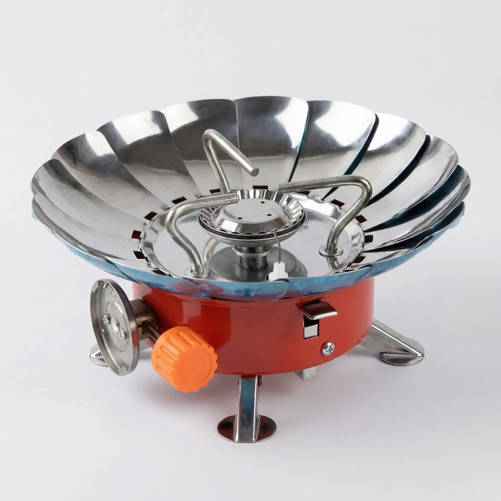 Lightweight folding backpacking stove, compact and windproof portable burner for reliable outdoor cooking.