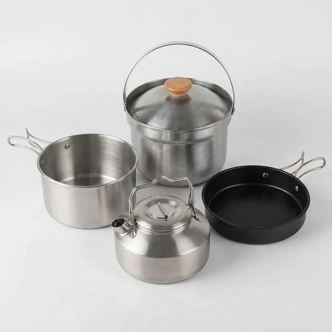 Portable camping cookware set with camp pot, frying pan, and kettle; essential hiking gear for outdoor kitchens.