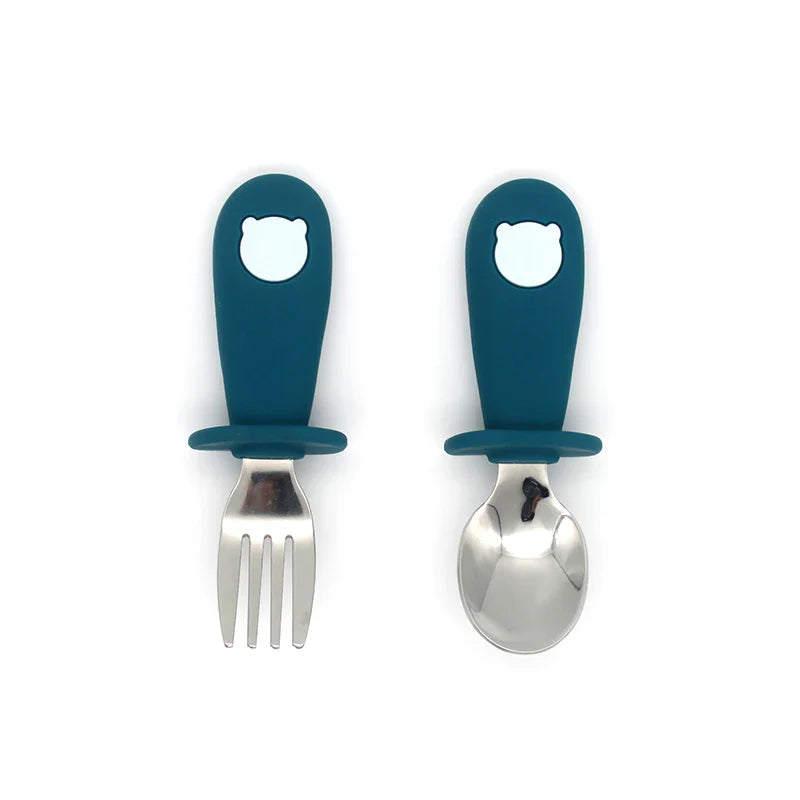 Educational self-feeding set for toddlers: silicone spoon, stainless steel fork, and silicone plate & bowl.
