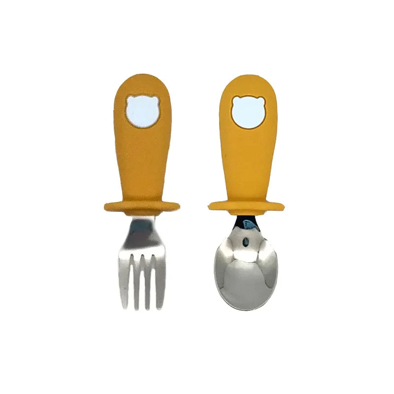 Modern baby tableware set in neutral grey, includes silicone plate, bowl, spoon, and stainless steel fork.