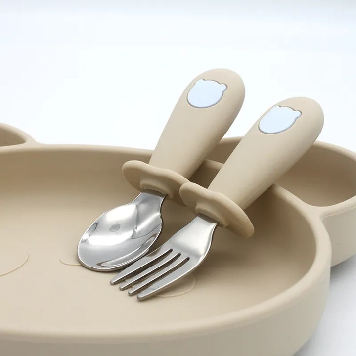 Silicone baby spoon with a comfortable handle and a small stainless steel fork for young eaters.