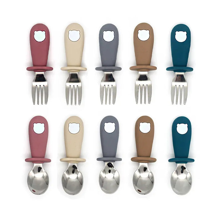 Premium silicone baby feeding supplies: suction plate, bowl, soft-tip spoon, and stainless steel toddler fork.