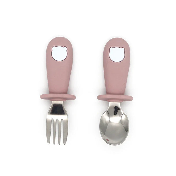 Full view of a silicone baby tableware set with all components: bowl, plate, spoon, and stainless steel fork.