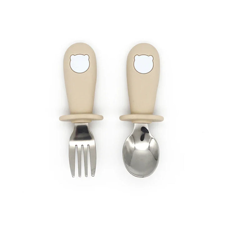 Stainless steel toddler fork with an easy-grip silicone handle, designed for little hands learning to eat.