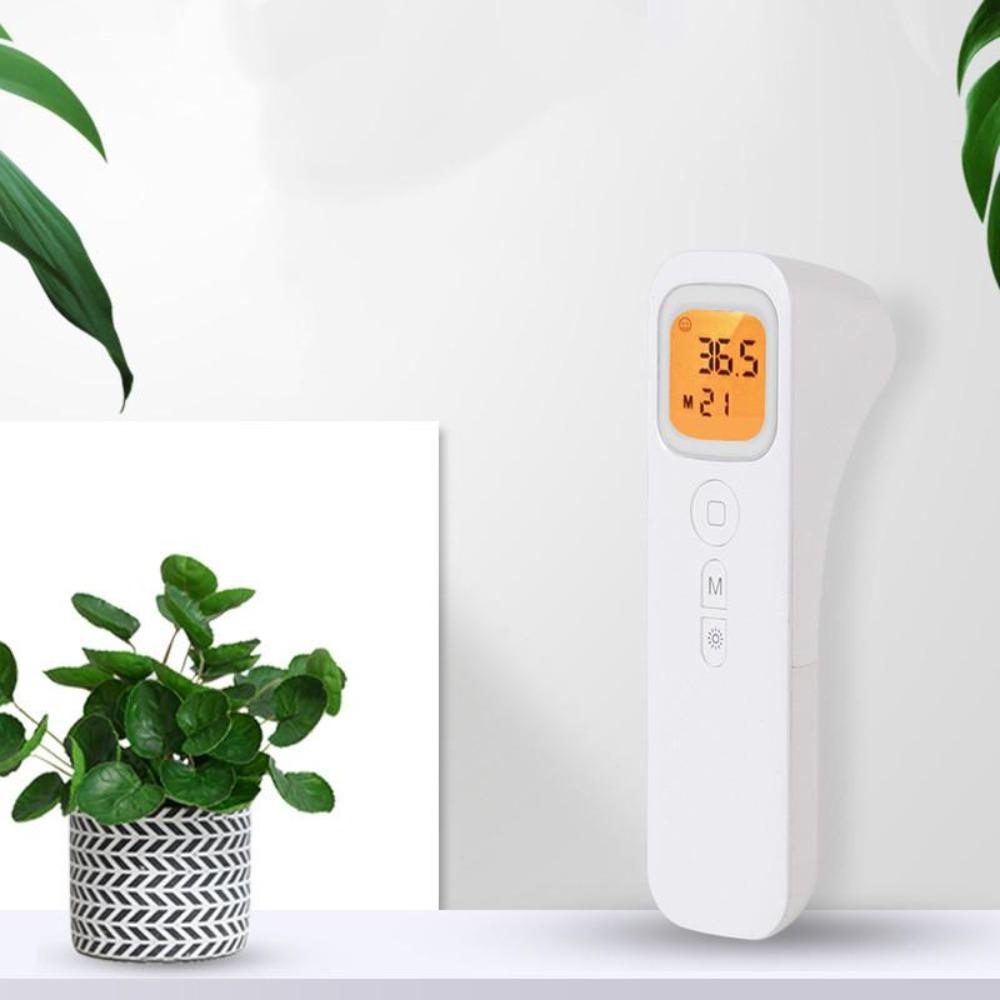 Hands holding a contactless infrared thermometer, emphasizing ease of use for baby health