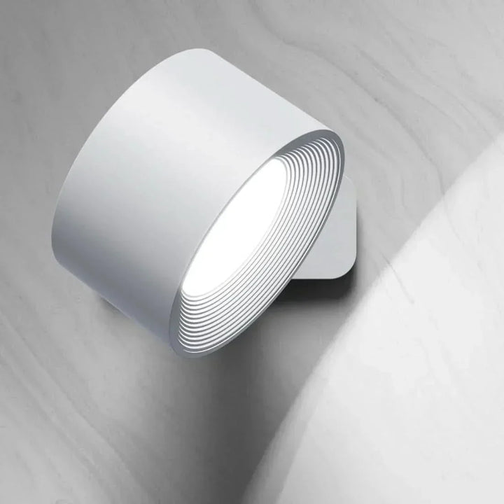 Magnetic LED wall lamp, rotatable head offers versatile, wireless lighting for modern home decor.