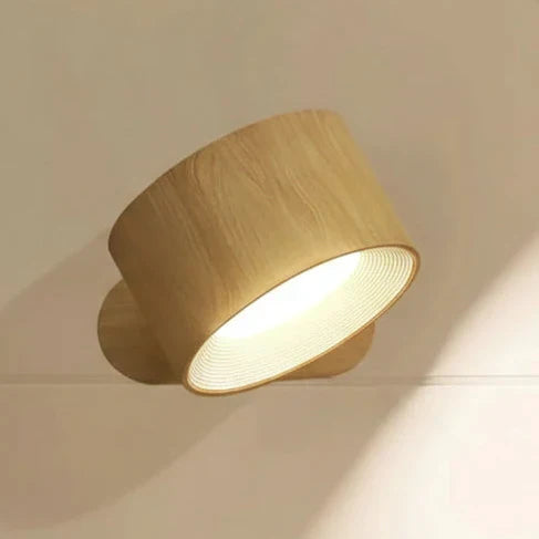 Portable magnetic LED light, rechargeable and rotatable, functions as a cordless wall lamp or task light.