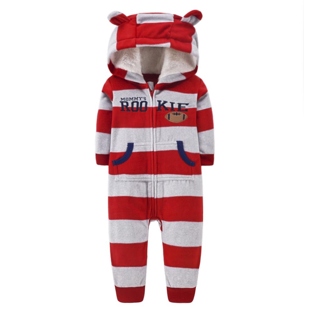 Detail of dragon scales on striped hooded infant jumpsuit, soft baby romper