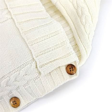 Delicate beige soft knit acrylic baby swaddle wrap. Cozy infant blanket for newborn warmth.