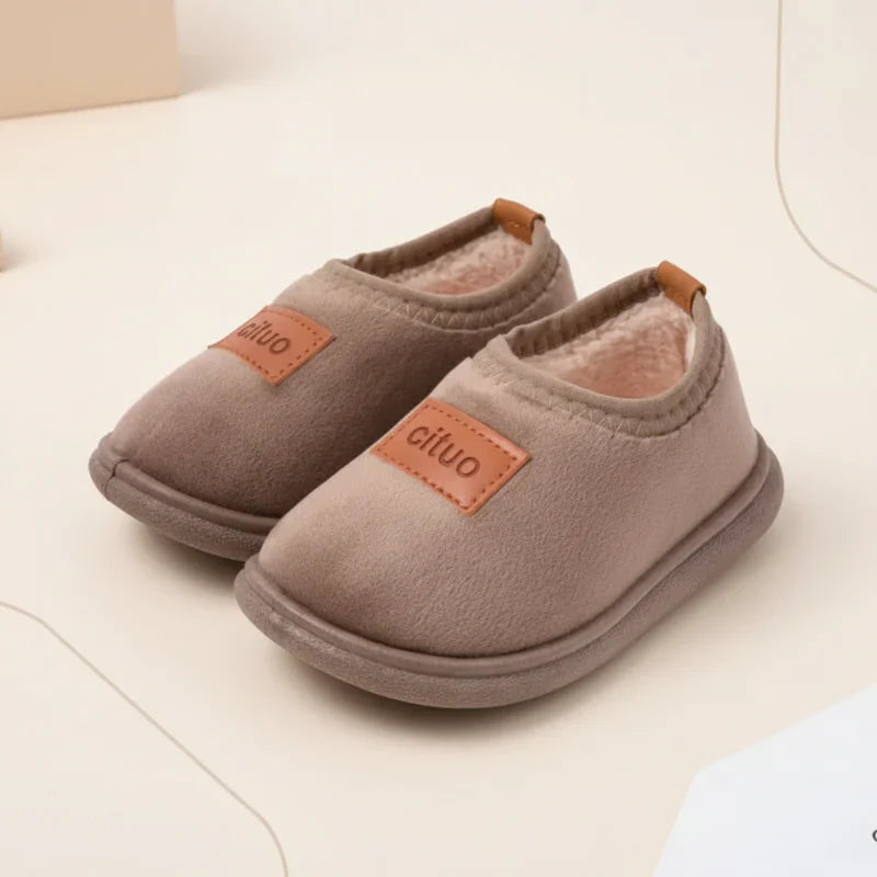 Snug baby winter slippers, suede upper and anti-slip bottom for cozy indoor play.